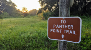 Panther Point Trail sign at sunrise | Sunday Morning Hike on Panther Point Trail | Marshall Hampton Reserve in Winter Haven, FL | Spark Explore